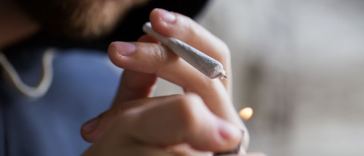 man lighting up joint