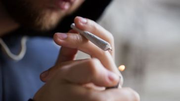 man lighting up joint