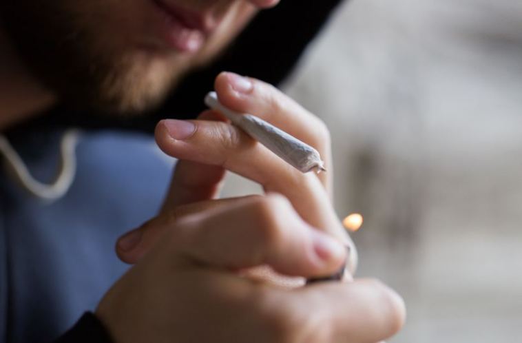 man lighting up joint