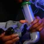 man smoking bong