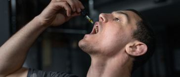man taking CBD tincture
